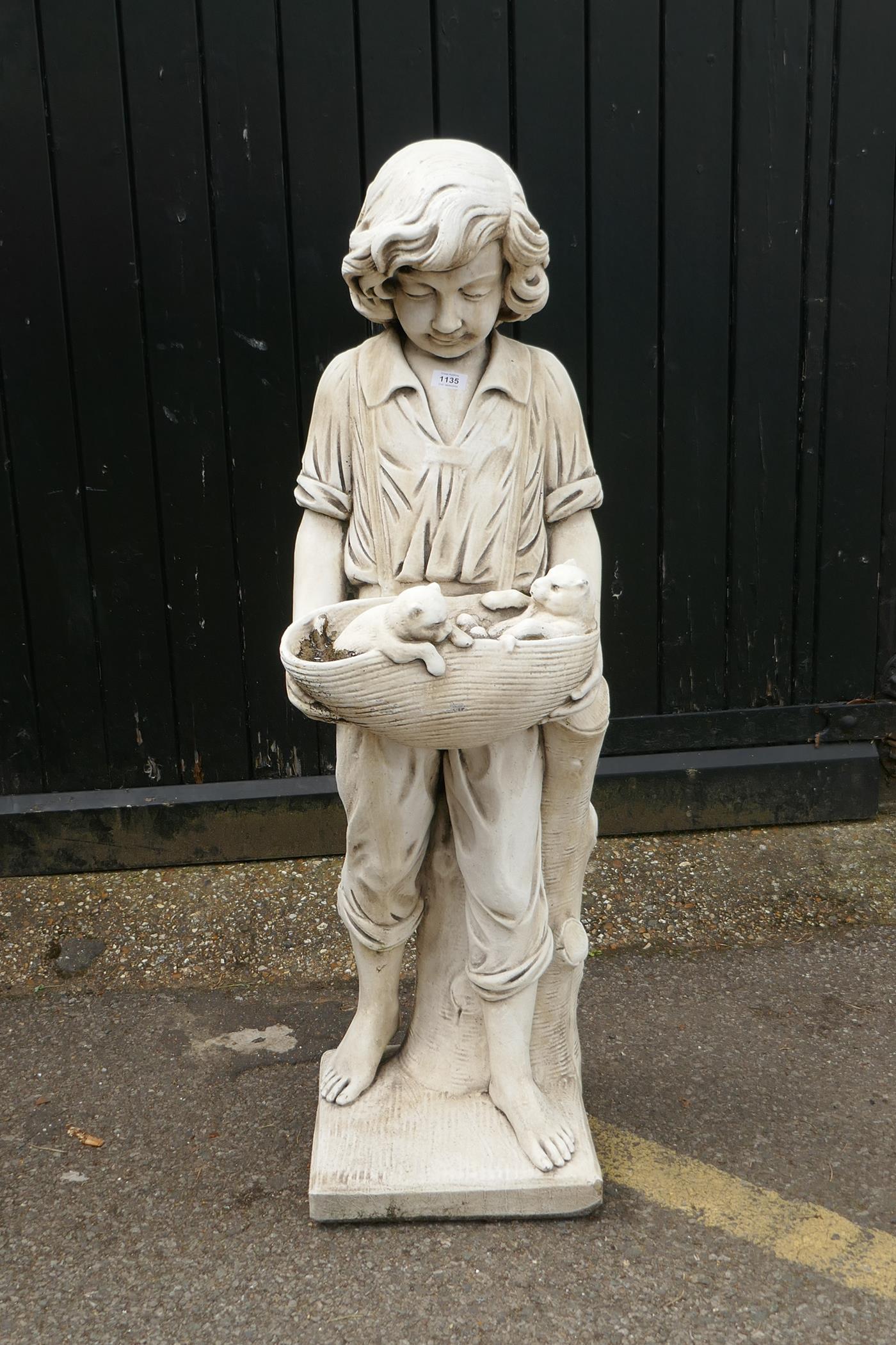 A painted reconstituted stone/concrete garden figure, boy with two puppies, 120cm high