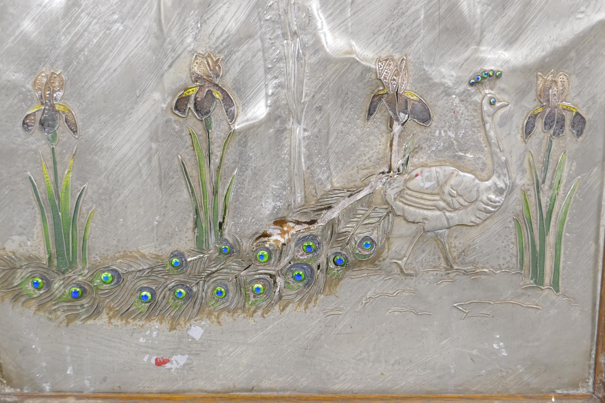 An Arts & Crafts firescreen with inset pewter and enamel panel, decorated in repousse with a peacock - Image 2 of 4