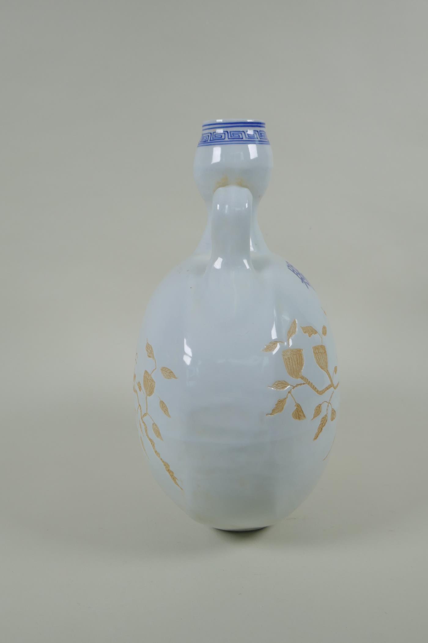 A Chinese blue and white porcelain moon flask with two handles and chased decoration of birds on a - Image 2 of 4