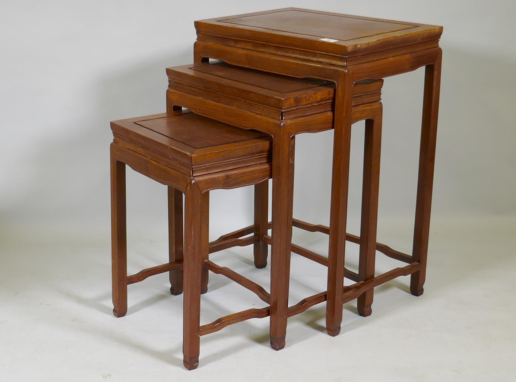 A nest of three Chinese hardwood occasional tables, 48 x 36 x 69cm