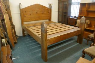 An oversize pine bed, the head boards capped with metal mounts, by repute formerly the property of