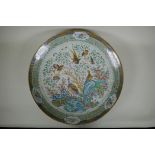 An C18th/C19th Chinese famille verte porcelain charger decorated with peacocks and asiatic birds