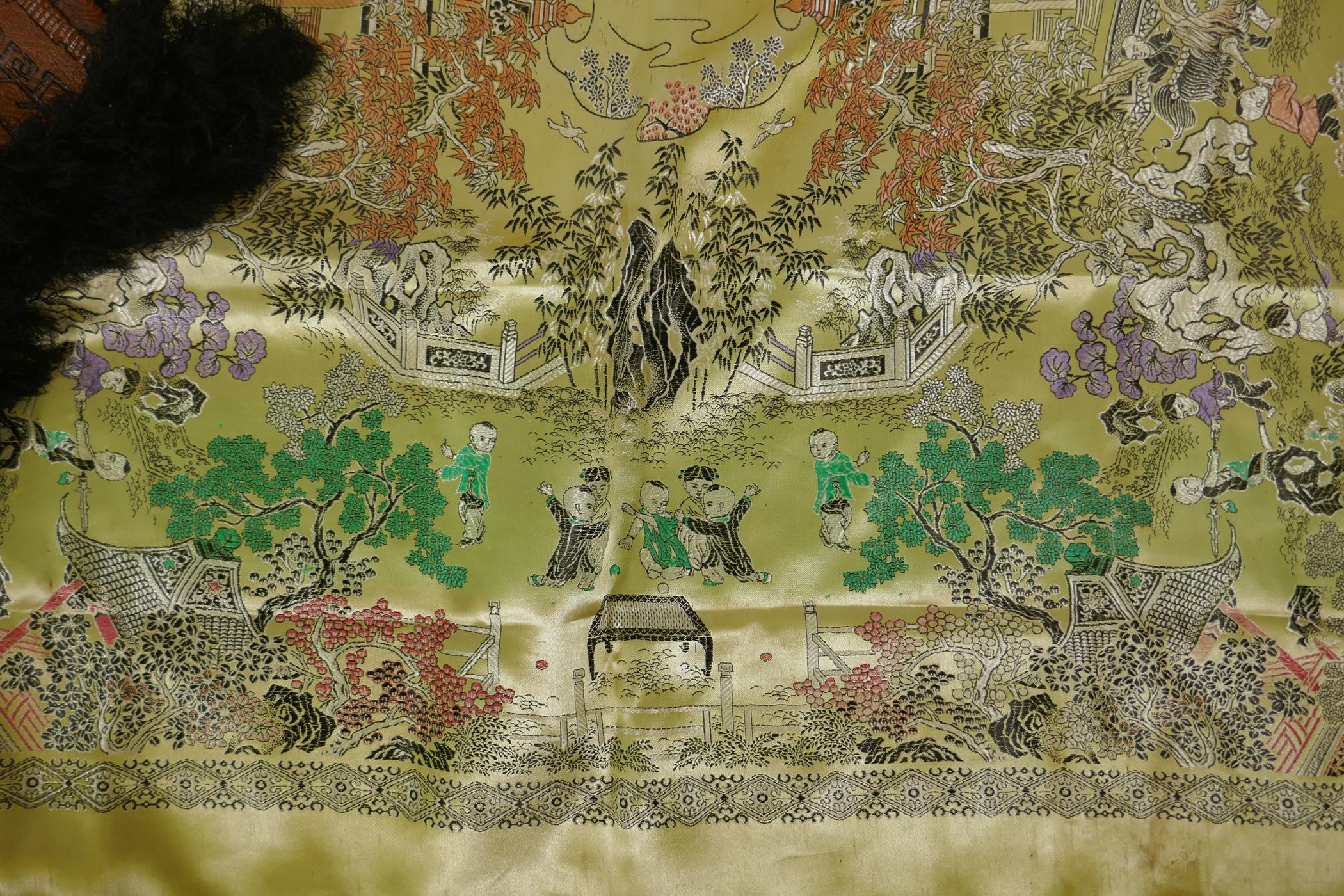 A Chinese machine embroidered gold ground silk throw decorated with boys playing in a garden, - Image 3 of 5