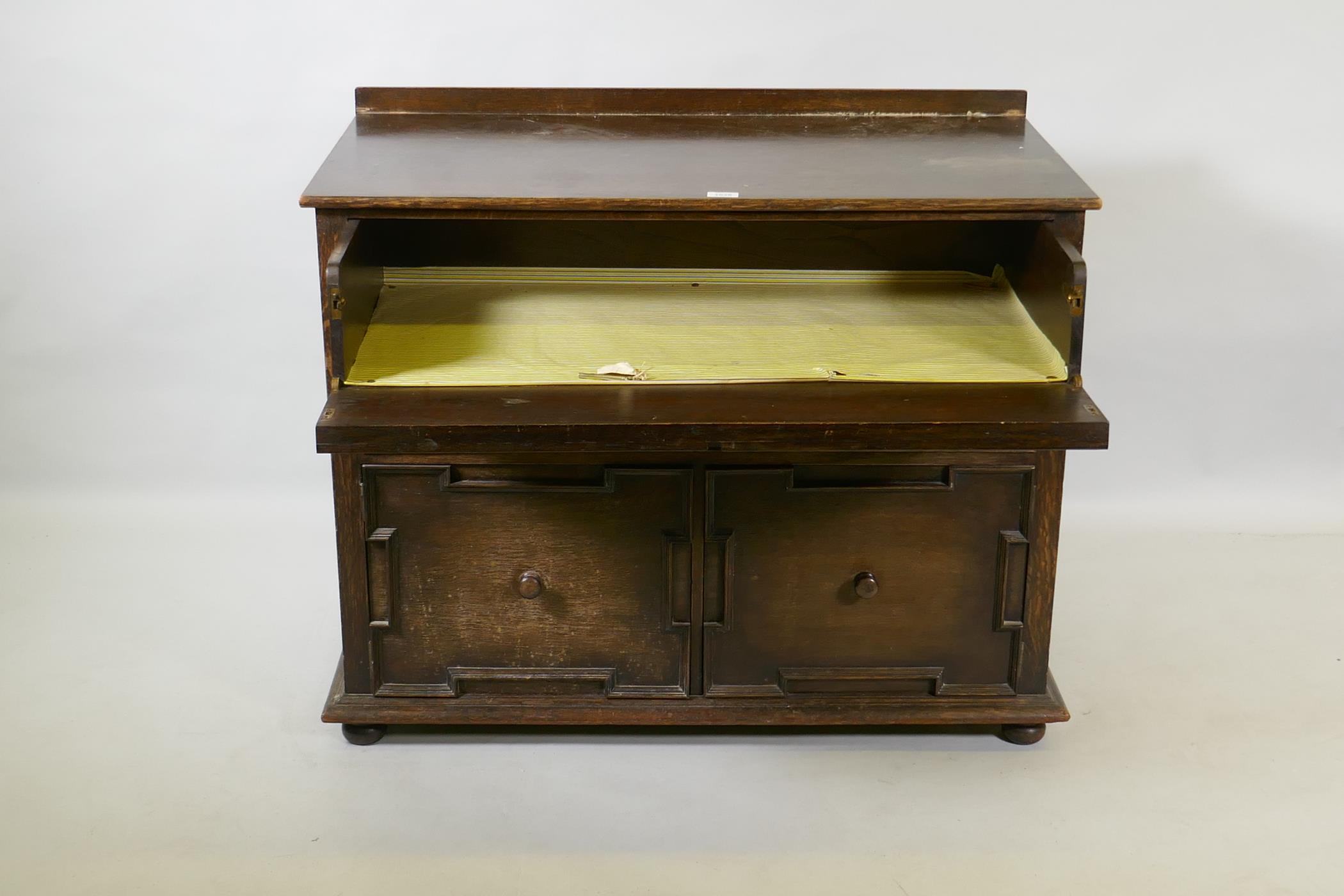 A Jacobean style oak cabinet, the top drawer with fold down front over a single drawer and two - Image 2 of 3