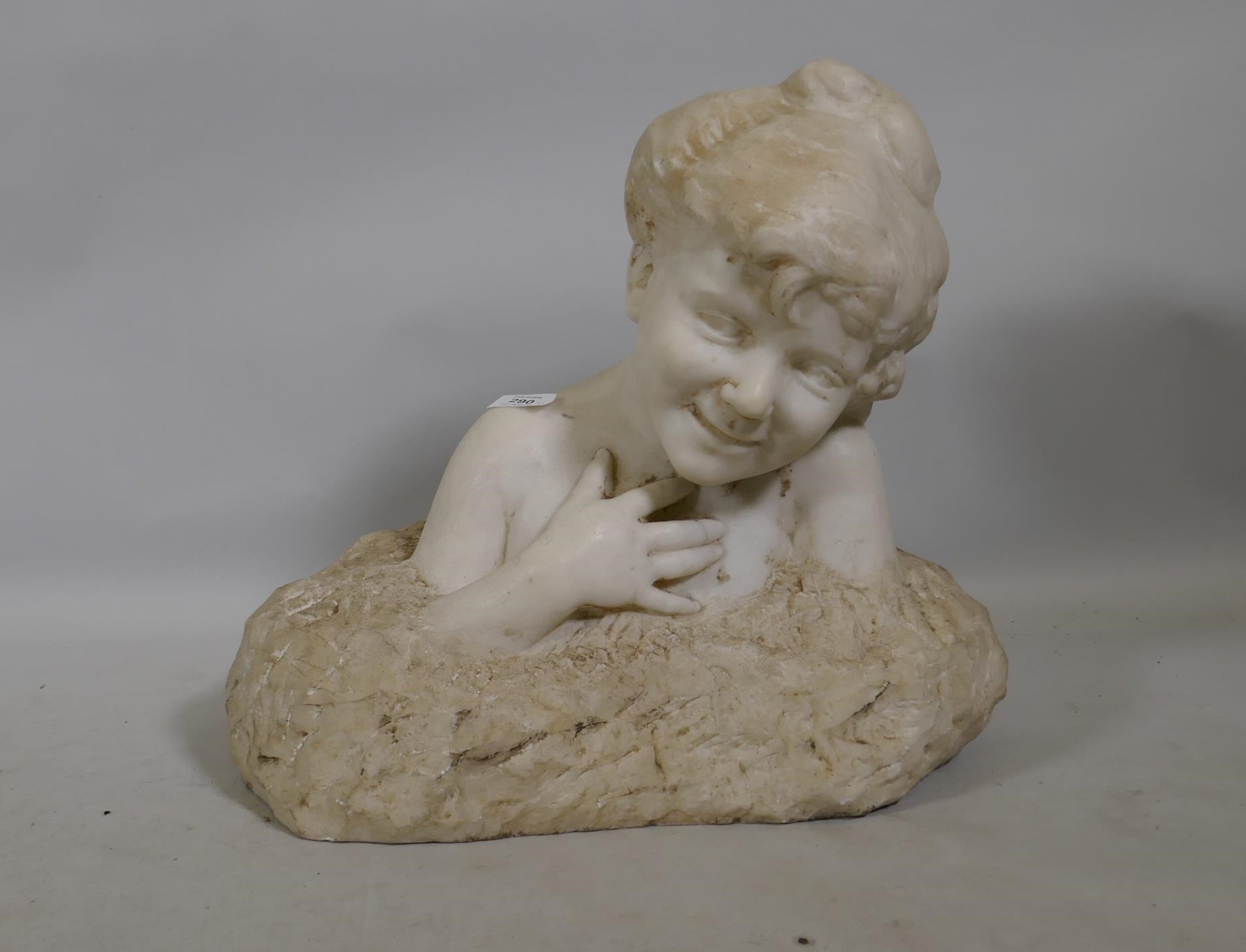 A C19th marble bust of a smiling child, signed indistinctly A. Holandoff?, 42cm high