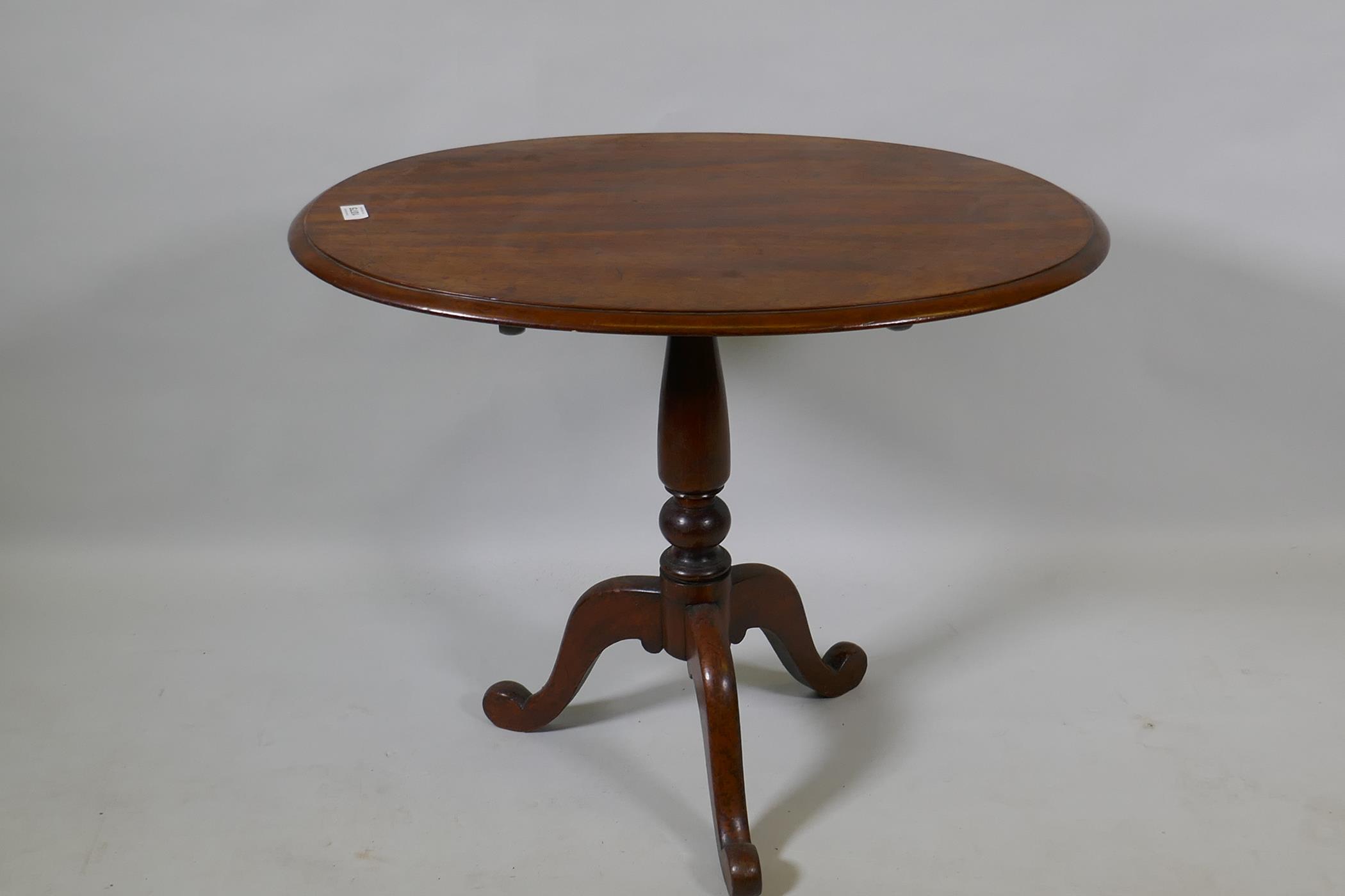A Victorian mahogany tilt top occasional table, raised on turned column and tripod supports, 54 x 75 - Image 2 of 3