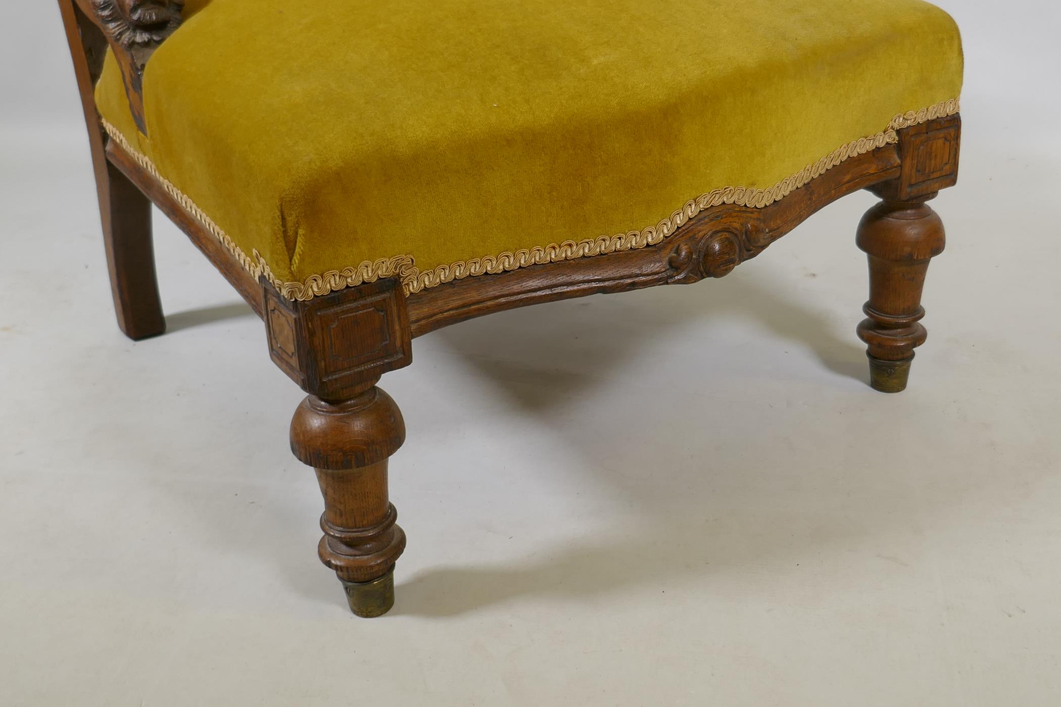 A C19th oak nursing chair with carved lion mask decoration, raised on turned supports - Image 2 of 4