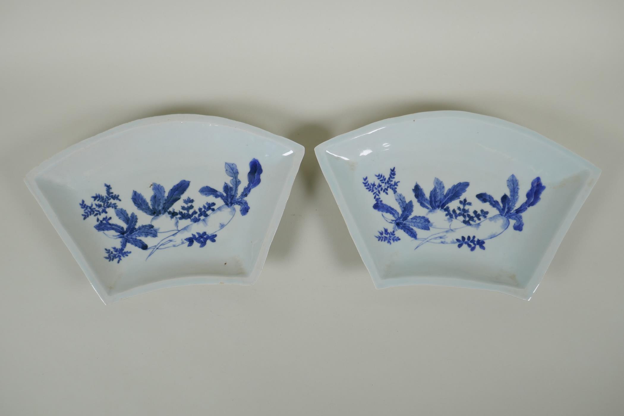 A pair of C19th Japanese blue and white porcelain fan shaped dishes decorated with root