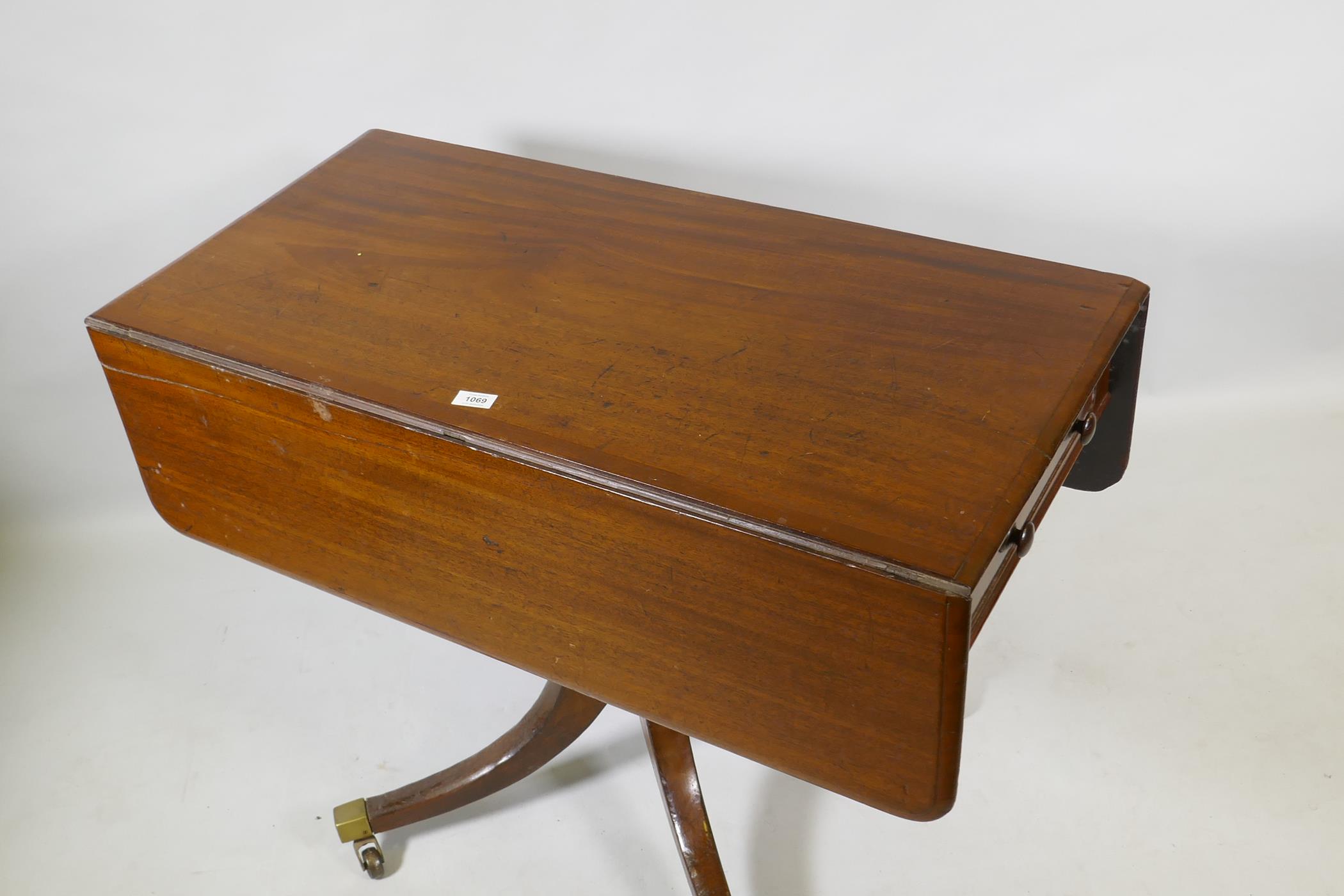 A Georgian mahogany pembroke table with one true and one false drawer, raised on a turned column and - Image 2 of 4