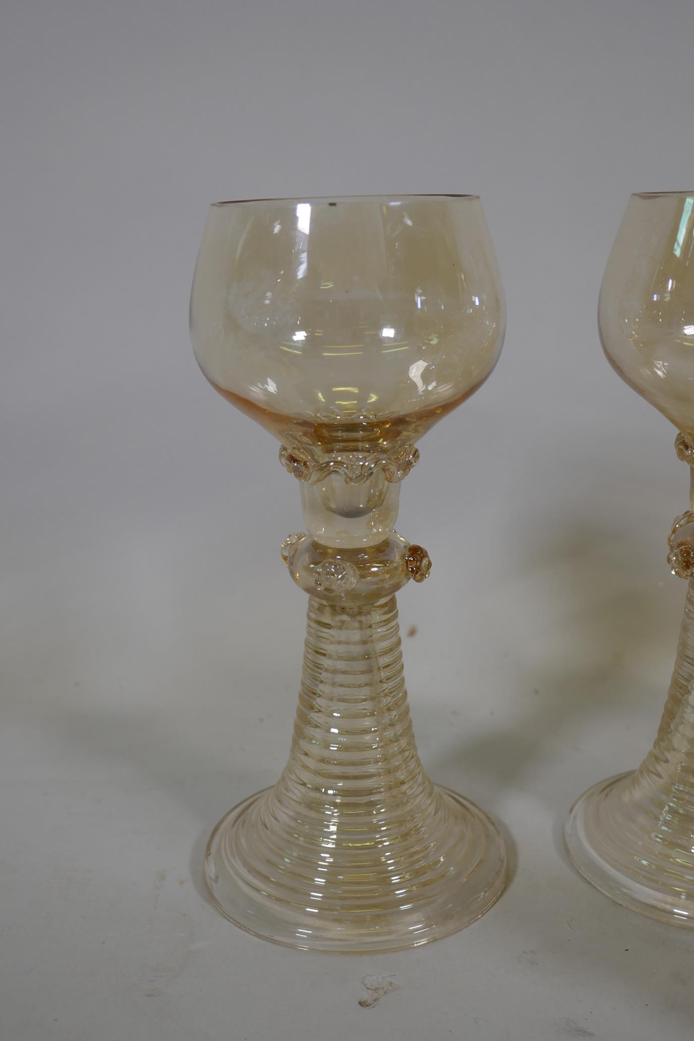 A set of seven C19th amber coloured Hock wine glasses, and five more similar with etched grape and - Image 4 of 4