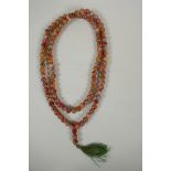 A string of multicolour hardstone/jade mala beads with the remnants of gilt lustre, 122cm long