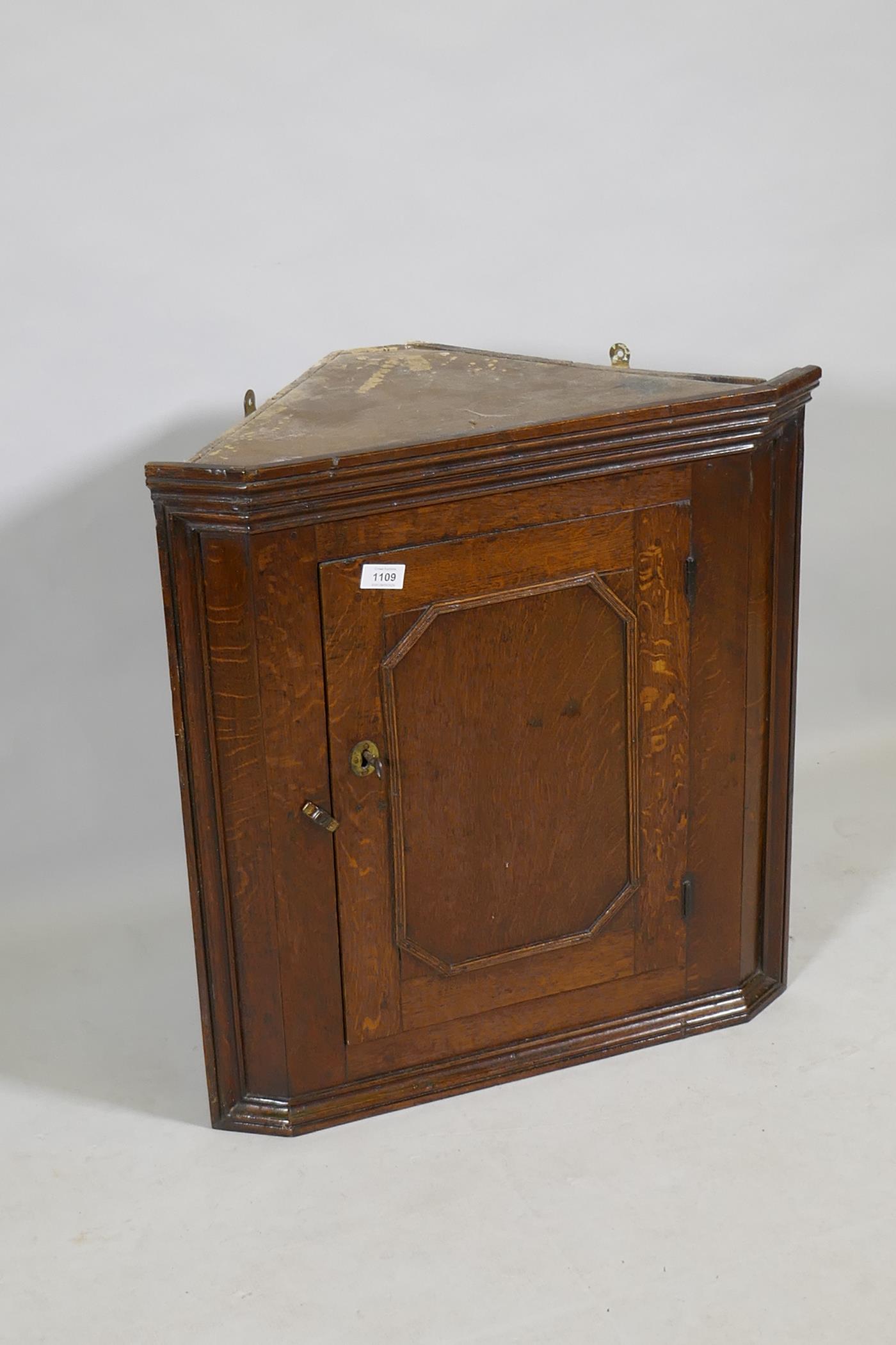 A Georgian oak hanging corner cupboard of small proportions, 66cm high - Image 2 of 3