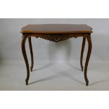 An early C19th French walnut serpentine shaped top centre table, with carved frieze, raised on