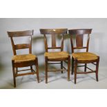 A harlequin set of three antique provincial rush seated dining chairs