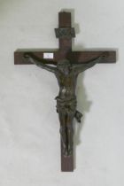 A C19th Continental bronze Corpus Christi, mounted on an oak crucifix with tablet, marked AA,