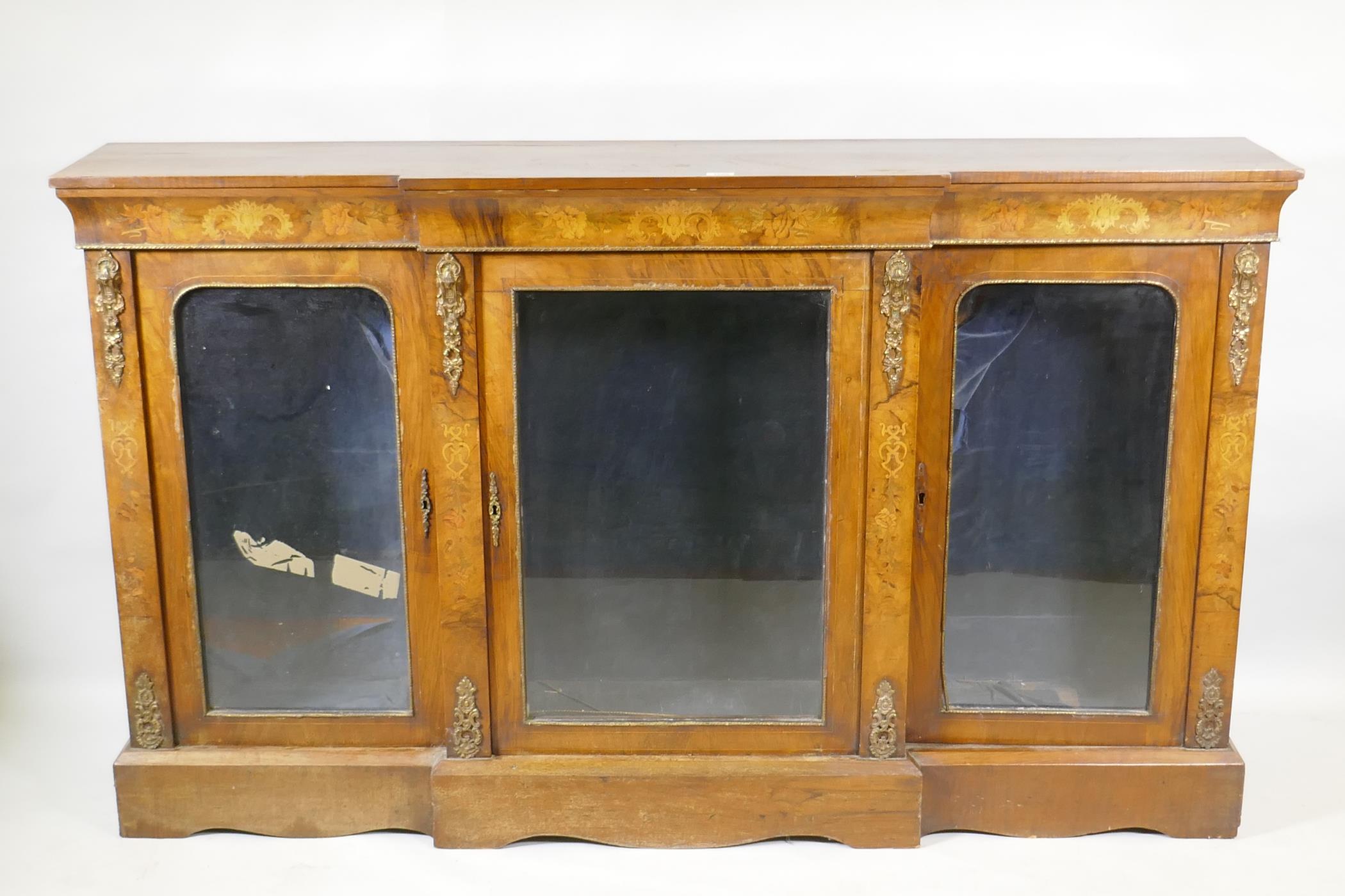 A Victorian marquetry inlaid breakfront walnut credenza with moulded frieze top over three arched