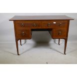 A Victorian mahogany kneehole desk with satinwood banding inlay and brass handles, four drawers