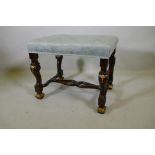 A mahogany stool with carved and parcel gilt decoration, raised on shaped and scrolled supports