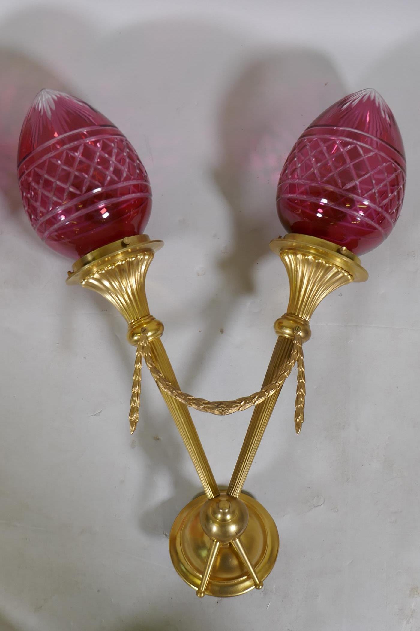 A pair of ormolu two branch wall lights with cranberry glass shades, 57cm long - Image 2 of 3