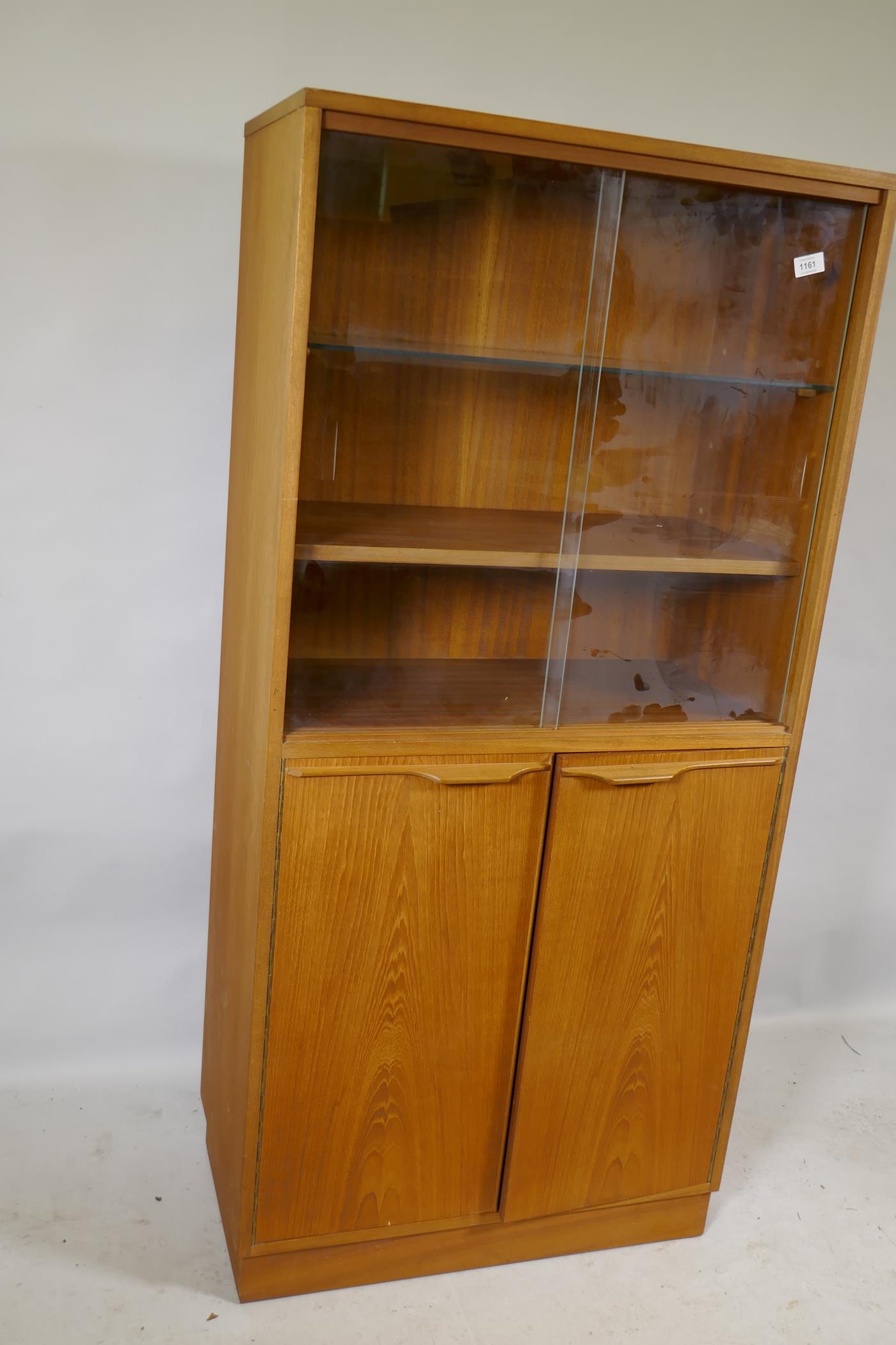 A mid century teak cabinet, with sliding glass doors over two cupboards, 69 x 36 x 144cm - Image 2 of 2