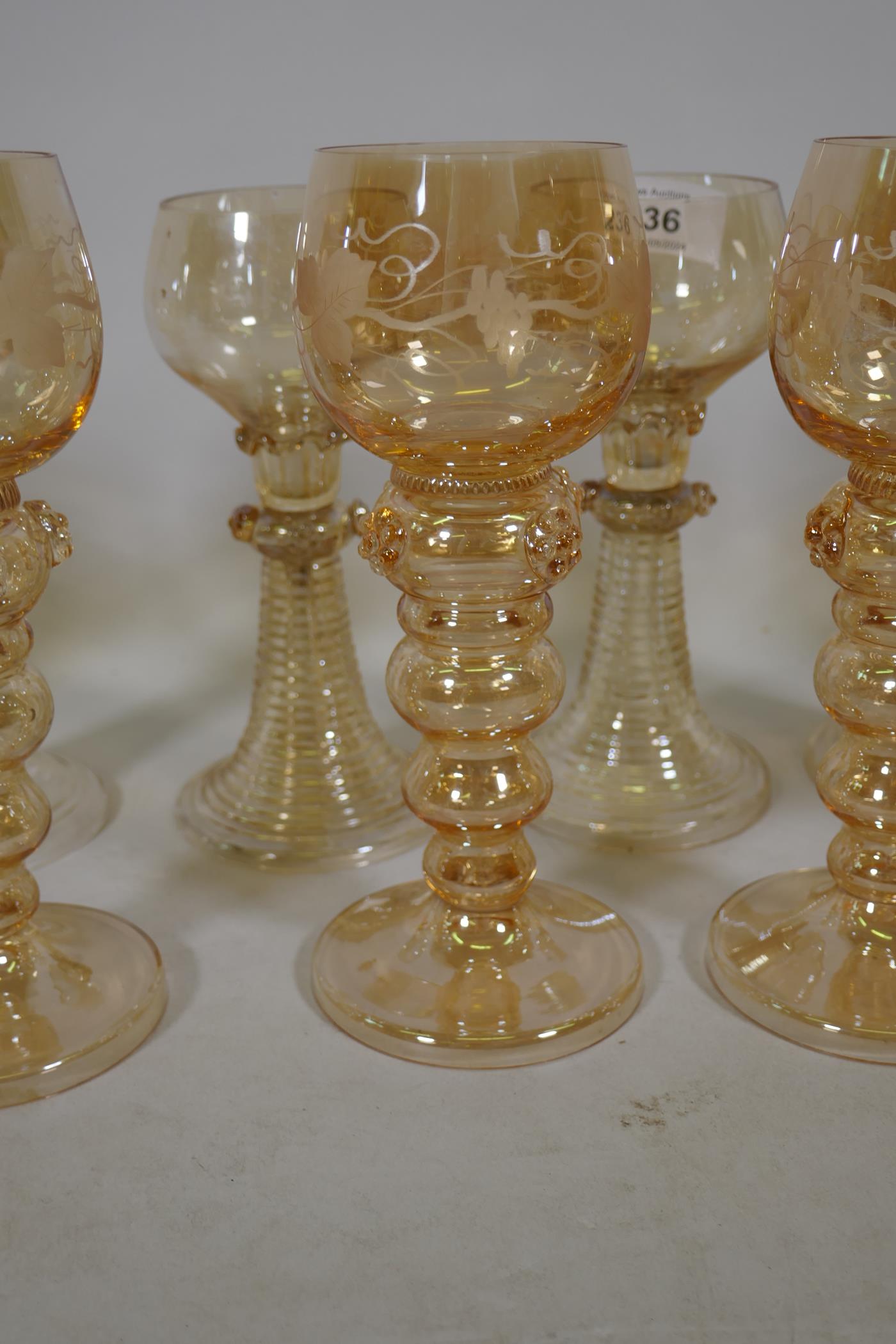 A set of seven C19th amber coloured Hock wine glasses, and five more similar with etched grape and - Image 3 of 4