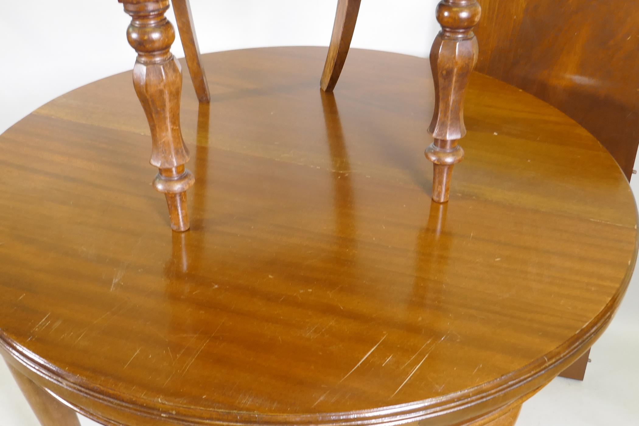 A mahogany wind out dining table, 109cm diameter, with extra leaf, raised on cabriole supports, - Image 2 of 5
