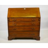 A Georgian mahogany bureau, the fall front with fitted interior over four long drawers with brass