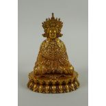 A Sino Tibetan filled gilt bronze Buddha seated on a lotus throne, double vajra mark to base, 11cm