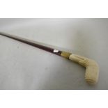 A hardwood walking cane with ivorine handle, 96cm long