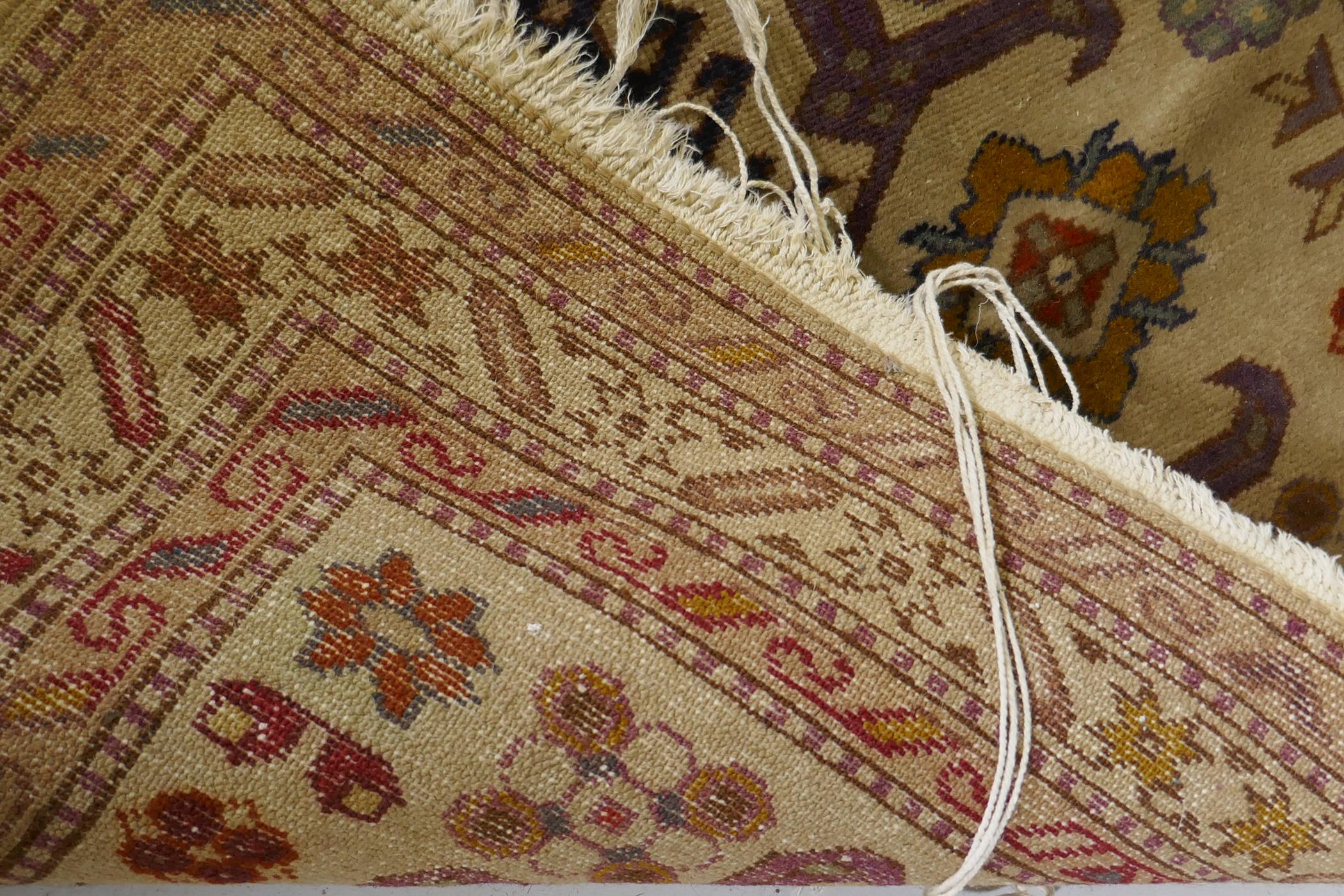 An antique hand woven Oriental rug with geometric designs n a buff coloured field, 68 x 125cm - Image 3 of 3