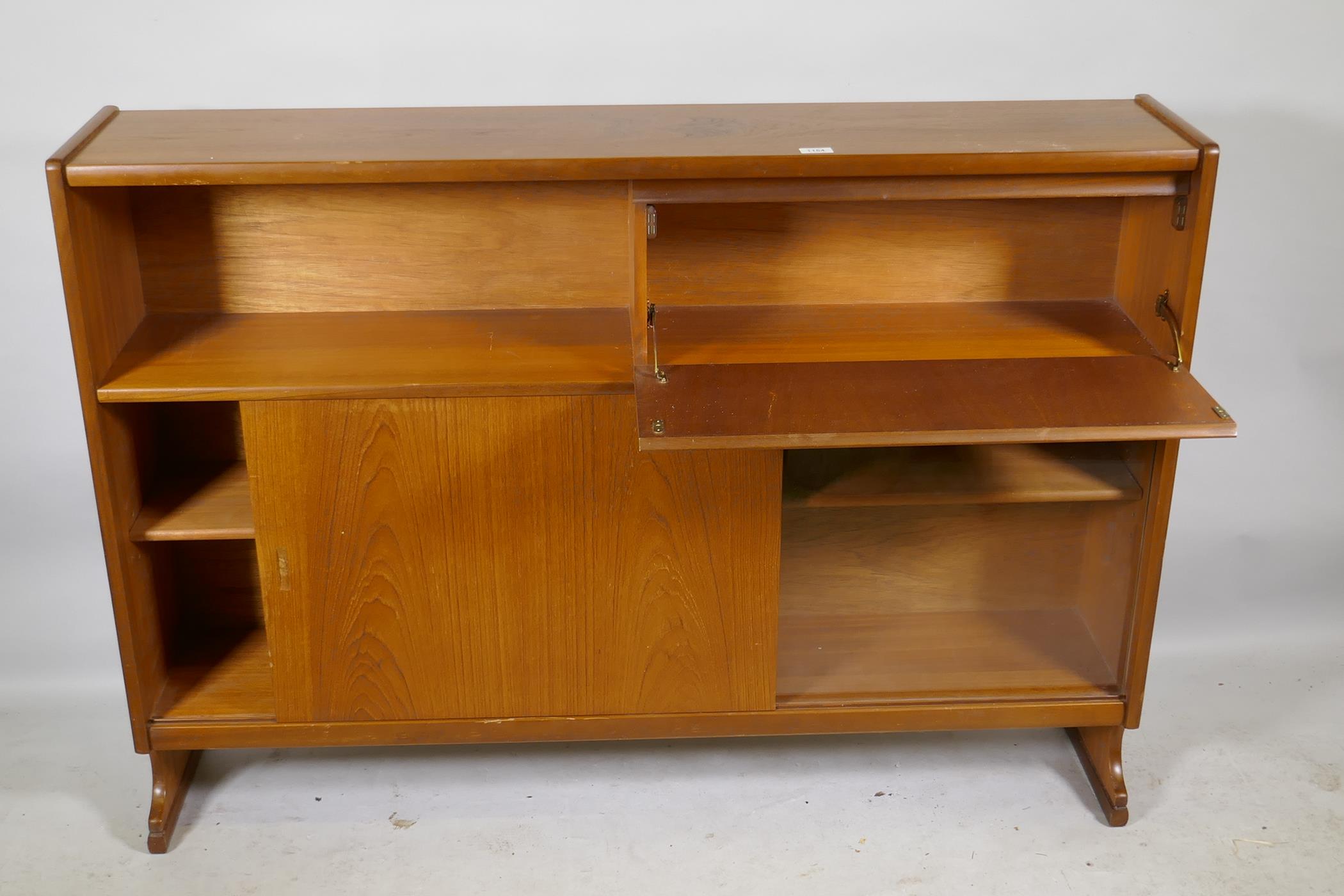 A mid century Nathan teak bookcase with open shelf and fall front over two sliding doors, raised - Image 2 of 3