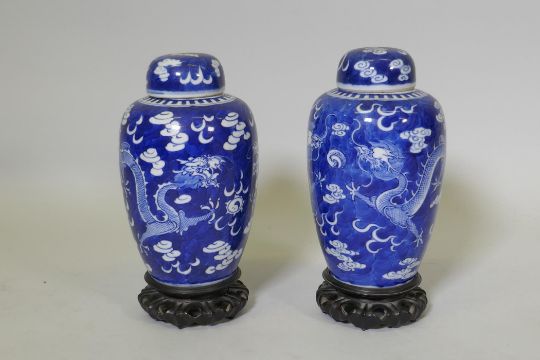 A pair of antique Chinese blue and white dragon jars with covers, KangXi four character mark to - Image 1 of 7