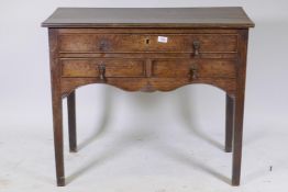 Early C19th oak side table, with single drawer over two more, shaped and carved apron and square