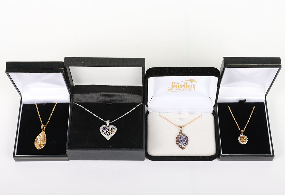 Four modern 9ct and gem set pendant necklaces