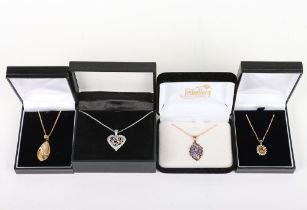 Four modern 9ct and gem set pendant necklaces