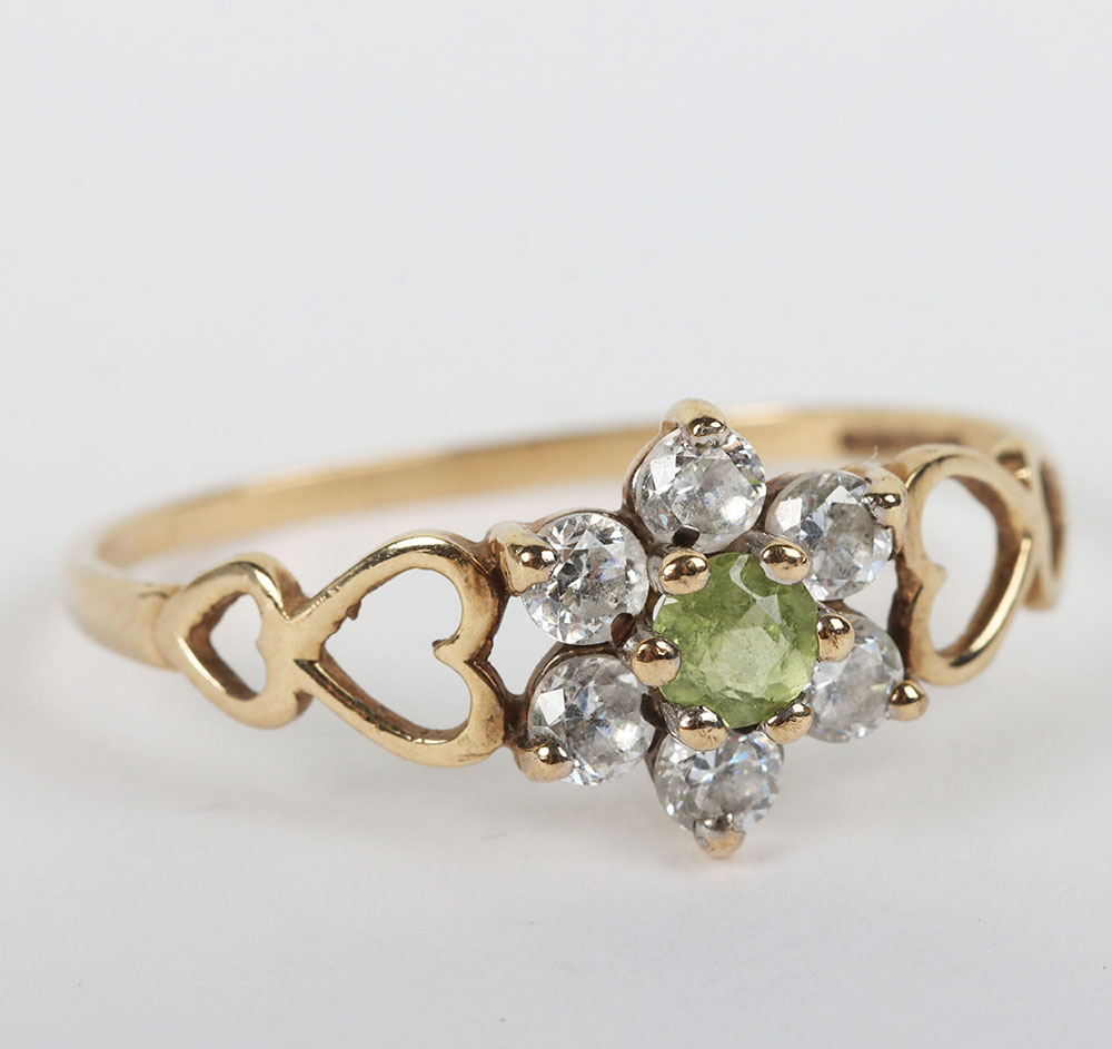 A group of four 9ct rings, including a 9ct ruby flower set ring, with a peridot and diamond ring, a - Image 6 of 6