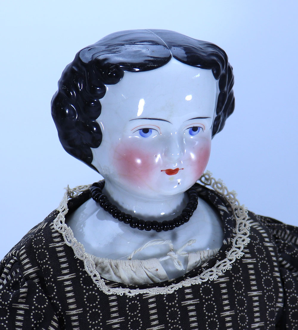 A glazed china shoulder head doll, German 1860s,