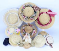 A selection of dolls and children’s dresses, together with a good amount of doll repair items,