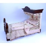 A Victorian mahogany Half-Tester Dolls bed with pink and white drapes,