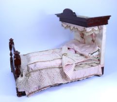 A Victorian mahogany Half-Tester Dolls bed with pink and white drapes,