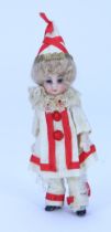 A miniature all original all-bisque doll in clown outfit, German circa 1910,