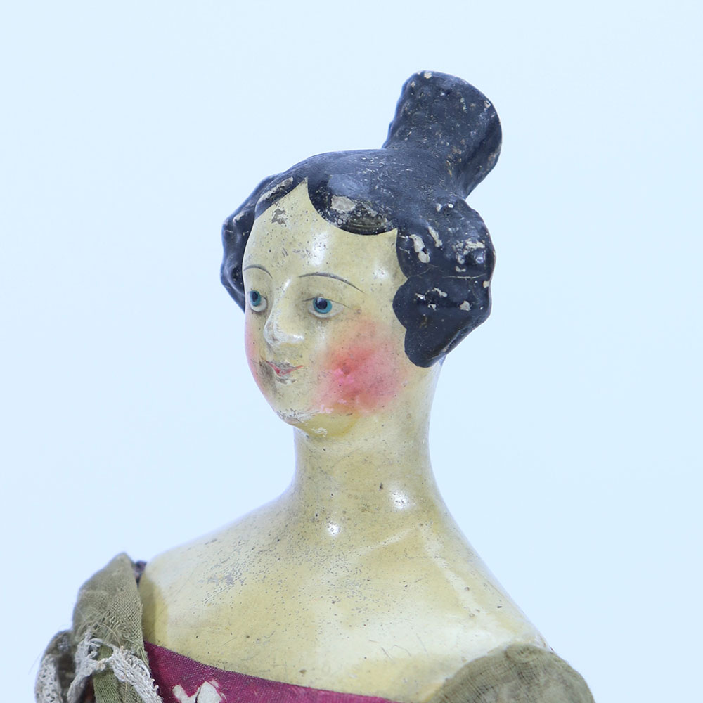 A papier-mache shoulder head doll, German 1840s,