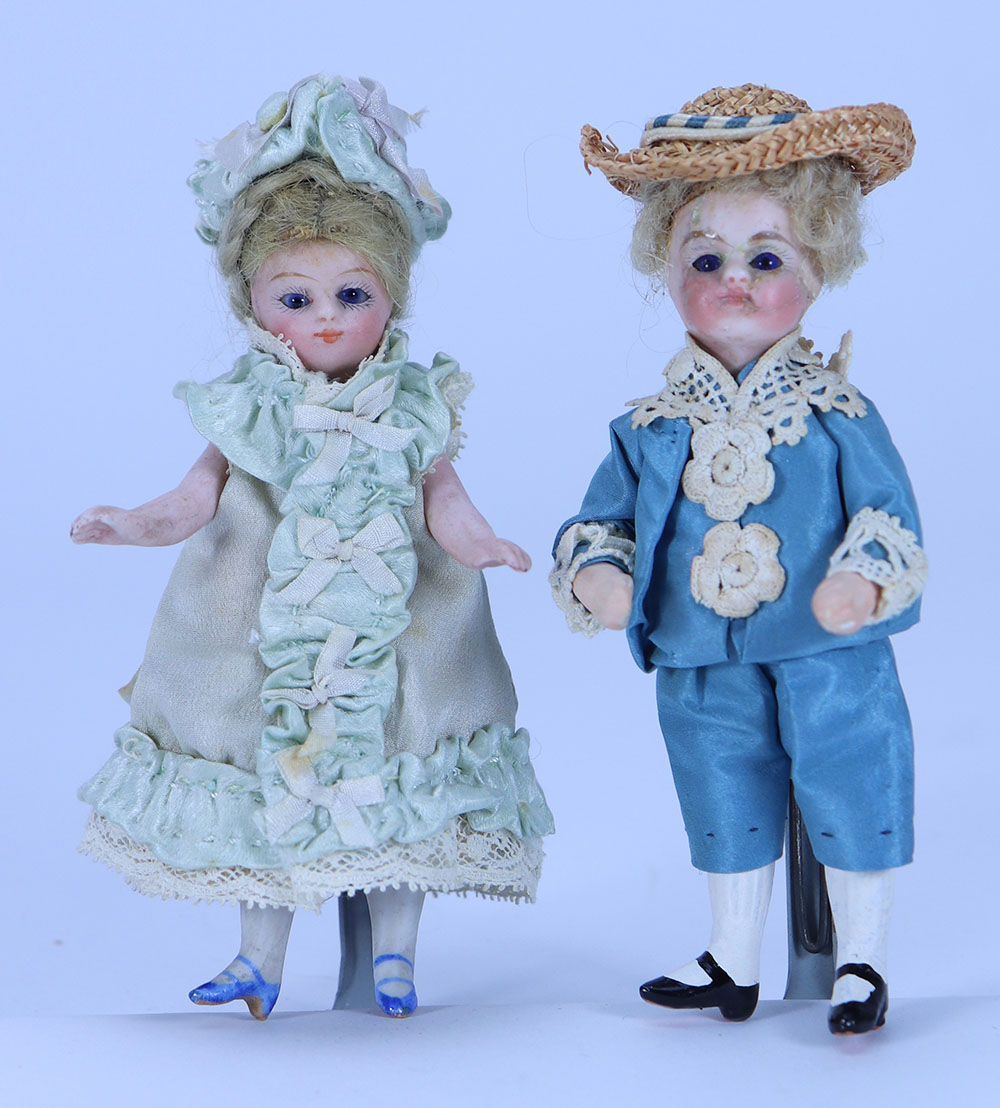 A miniature mignonette all-bisque doll in original blue silk dress, French circa 1890,