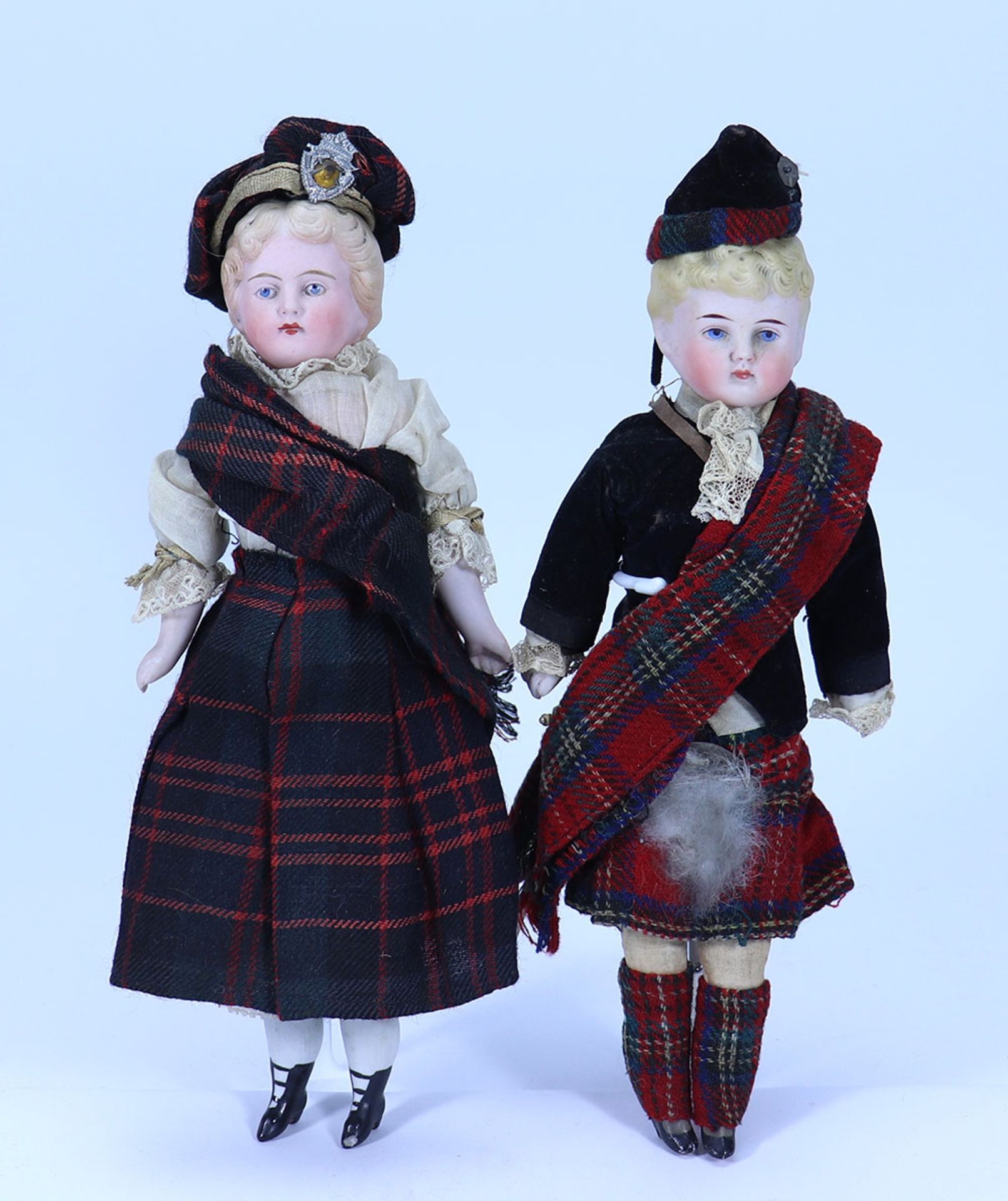 A pair of Parian-type shoulder head dolls in Scottish costumes, German circa 1890,