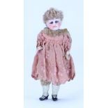A miniature bisque head doll in original clothes, German circa 1910,
