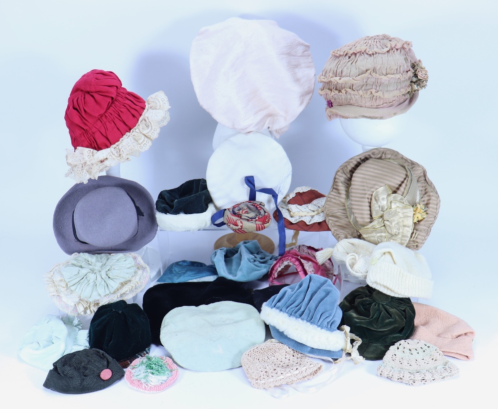 A collection of various dolls bonnets,
