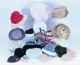 A collection of various dolls bonnets,