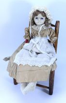 A wax over composition shoulder head doll, English circa 1860,