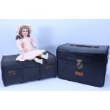 An A.M ‘Floradora bisque head doll in trunk with selection of clothes,