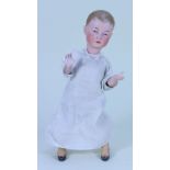 An unusual bisque head mechanical ‘walking’ doll, German circa 1910,